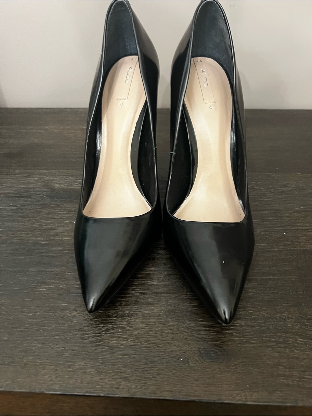 Classic ALDO black patent-finish pointed-toe pumps with a sleek 4.5-inch stilett